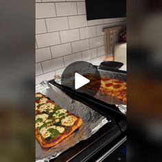 two pizzas sitting on top of pans in an oven