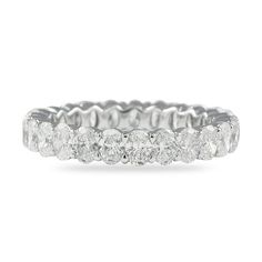 a white gold ring with five stones on the side and two rows of diamonds in each band