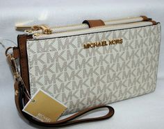 BRAND NEW with TAGS!  MICHAEL KORS  Jet Set Travel Double Zipped Wristlet LATEST FASHION VERY UNIQUE   100 % GUARANTEED AUTHENTIC or your money back !   7.25"L x 4.5"H x 1.5"W MK signature PVC and leather  MK gold Logo plaque on front  Water & stain resistant Polished gold hardware One phone case ( I phone 7 ) slot with button closure Double zipped closure with secure button closure 6 credit card slots, 1 ID window 12" long wristlet strap Original Michael Kors price tag   All items come from cle Hip Purse, Mk Wallet, Trendy Purses, Bag Obsession, Girly Bags, Wallet Wristlet, Handbags Women, I Phone, Michael Kors Wallet