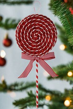 a candy lollipop ornament hanging from a christmas tree