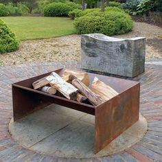 an outdoor fire pit with logs in it