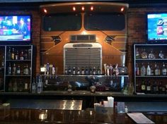 a bar with several televisions on the wall