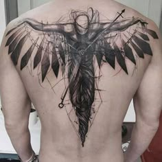 the back of a man's body with an artistic tattoo design on his chest