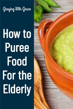 a bowl filled with green liquid next to a wooden spoon on top of a table