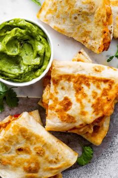 quesadillas with guacamole and salsa on the side, ready to be eaten