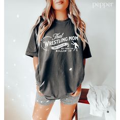 This wrestling mom shirt is the perfect tee to support your kid on game day! Our Comfort Colors tees and long sleeves are garment-dyed for that trendy distressed look. ♥ 》 》 OUR LOVE IT GUARANTEE《 《 Our shirts are backed by our Love It Guarantee. Your happiness is our top priority. This means that if for any reason you are unhappy with your purchase, message us within 14 days of receiving your shirt & we will refund your order in full or send you a new shirt right away! 》 》SIZING 《 《 The Comfort Colors tees are boxy cut and relaxed.  Refer to the Size Chart in the mockup photos.  If you want the oversized look, we suggest sizing up 1-2 sizes. 》 》PRODUCTION + SHIPPING《 《 * Order Production: 1-3 business days  * Standard Shipping: 2-5 business days after production time 》 》 ANATOMY OF OUR SH Wrestling Tshirt Ideas, Wrestling Shirts For Moms, Wrestling Mom Shirt, Wrestling Mom Shirts Ideas, Wrestling Mom Shirts, Youth Wrestling, Wrestling Shirt, Wrestling Team, Wrestling Shirts