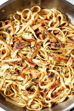 pasta with chicken and parsley in a pan