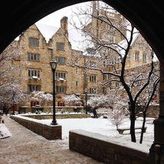 an arch in the middle of a snowy courtyard