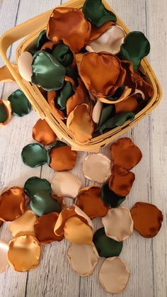 a basket filled with lots of brown and green flowers on top of a wooden floor