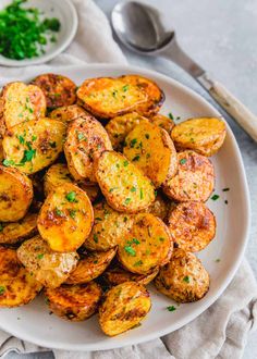 a white plate topped with fried potatoes and parsley