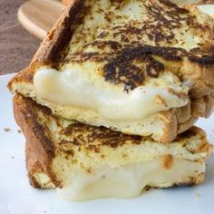 two grilled cheese sandwiches stacked on top of each other