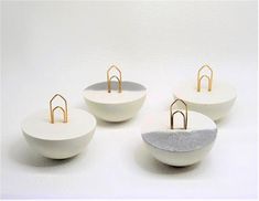 four white bowls with gold rings on them