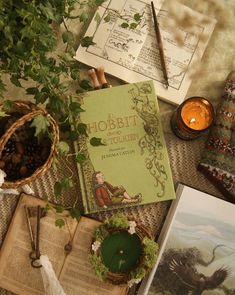 an open book sitting on top of a table next to plants