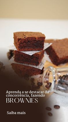 brownies are stacked on top of each other with coffee beans scattered around them and the caption reads,