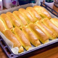 bread rolls are lined up on a baking sheet and ready to go into the oven