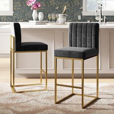 two black velvet bar stools in front of a kitchen counter with flowers on it