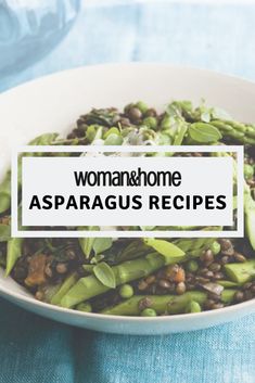 a white bowl filled with asparagus on top of a blue table cloth