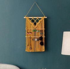 a room with a wall hanging made out of bamboo sticks and other things on it