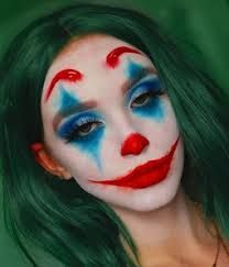 a woman with green hair and makeup is dressed in clown makeup for the photo shoot