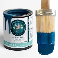 a paint can and brush next to it's blue tin with the word coastal on it