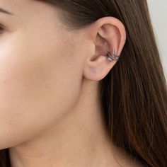 a woman wearing a pair of ear piercings