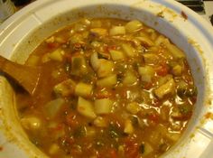 a white bowl filled with soup on top of a stove