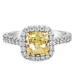 A gorgeous engagement ring, featuring a 2.01 carats cushion cut diamond certified by GIA as Fancy Light Yellow color and VVS1 clarity, set on a four prong setting made of 18K yellow gold. Accented by a halo of round brilliant cut diamonds that continue on to the shank in a half infinity French pavé setting. Diamonds weigh 0.51 carat total. Made with platinum. Size 6 US, resizable upon request. Roman Malakov is a custom house, specializing in creating anything you can imagine. If you would like t Yellow Diamond Engagement Ring Cushion, Cushion Cut Diamond Engagement Ring, Cushion Halo Engagement Ring, Yellow Diamonds Engagement, Yellow Diamond Engagement Ring, Fancy Light, Contemporary Engagement Rings, Engagement Ring Prices, Cushion Cut Diamond