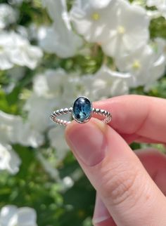 This ring is handmade by me using 925 sterling silver. It has a 2 mm wide beaded ring band and is set with an oval moss kyanite (6x8 mm) in a beautiful shade of teal. This ring is a size 8 (US) and has an inside diameter of 18 mm. Inside ring diameter: 18 mm (US size 8) Ring band width: 2 mm Stone size: 6x8 mm Love this ring, but it's not your size? Send me a message and I'll let you know what the options are! - Every piece in my shop is made by hand, which makes them unique and perfectly imperf Dainty Blue Sapphire Ring In Sterling Silver, Blue Sapphire Ring In Sterling Silver, Blue Sapphire Ring In Sterling Silver, Dainty Style, Handmade Blue Topaz Ring In Sterling Silver, Handmade Blue Crystal Ring In Sterling Silver, Ring With Blue Stone, Large Stone Rings, Beaded Ring, Small Jewelry