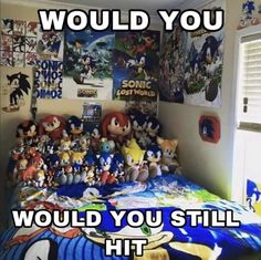 a bedroom with sonic the hedgehog pictures on the wall and stuffed animals on the bed