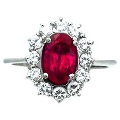 1.7 Carat No Heat Ruby Diamond 18K White Gold Cluster Ring Classically cluster ruby diamond ring, the oval top is set with a natural ruby ​​of 1.70 ct in a setting of 12 radiant diamonds with a total of 0.72 ct, in a grid-like openwork setting made of high-quality white gold, in which the fire and the play of colors of the selected stone can unfold. This ring is supplied with an independent appraisal. 750 white gold 1 natural ruby, 1.7 ct oval faceted (8.41 x 5.42 mm) 12 brilliants total 072 ct