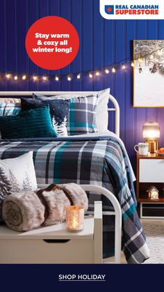 a bed room with a neatly made bed and christmas lights on the wall behind it