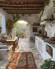 an outdoor kitchen and dining area with stone walls, flooring and potted plants