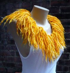 a white mannequin with yellow yarn on it