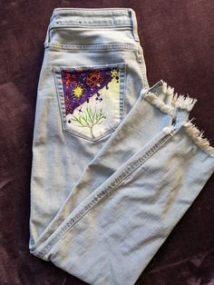 This is a Hollister mom jean type pant size 7 w 28 with a hand-painted design on the left back pocket. I use sustainable denim found at local thrift shops and closets to create the most unique creations. Embroidered Light Wash Denim Jeans, Embroidered Medium Wash Relaxed Fit Jeans, Upcycled Medium Wash Straight Leg Bottoms, Medium Wash Upcycled Straight Leg Bottoms, Upcycled Straight Leg Bottoms For Spring, Upcycled Medium Wash Straight Leg Jeans, Upcycled Straight Leg Jeans In Medium Wash, Upcycled Medium Wash Jeans For Spring, Upcycled Straight Leg Medium Wash Jeans