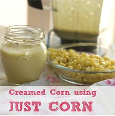 a glass bowl filled with corn next to a jar of cream