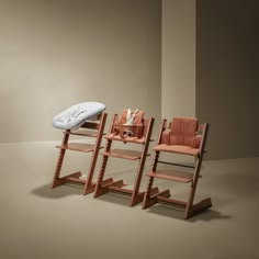 two wooden chairs and a baby changing table