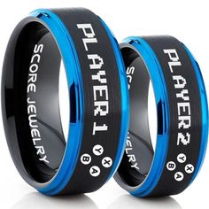 two black and blue wedding bands with white lettering on the sides, one is for each other