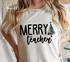 a woman wearing a t - shirt that says merry teacher with a christmas tree on it