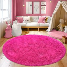 a living room with pink walls and rugs on the floor in front of a white couch