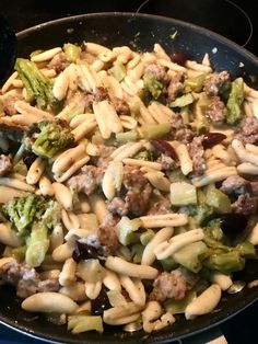 pasta with sausage and broccoli in a skillet