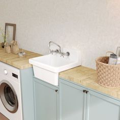 a washer and dryer in a small room with wood flooring on the walls