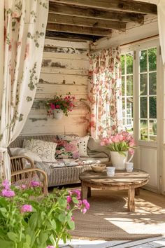 a living room filled with furniture and flowers