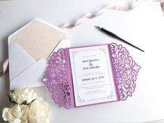 the wedding stationery is laid out on top of the card and envelope, along with some flowers