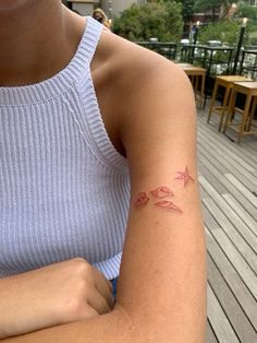 a woman with a small tattoo on her arm