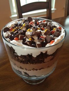 a dessert in a glass bowl with candy and marshmallows on the top