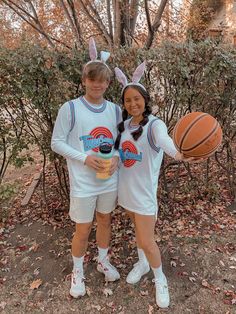 two people in bunny ears are holding basketballs