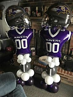 two football helmets with balloons attached to them