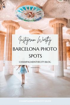 a girl in a blue dress is walking through an ornate building with columns and chandelier