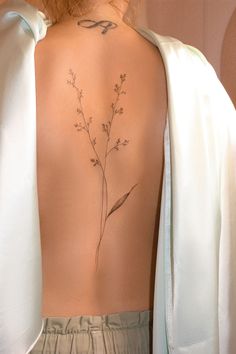 the back of a woman's neck with flowers on it