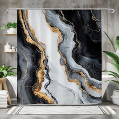 a shower curtain with black, white and gold marble design on it in a bathroom